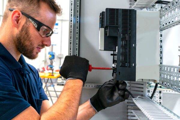 Electrician working at electric panel