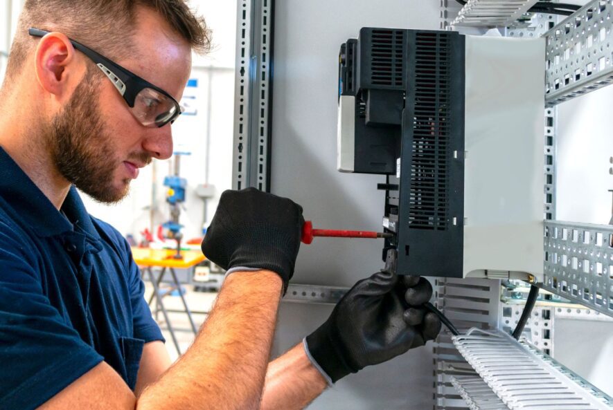 Electrician working at electric panel