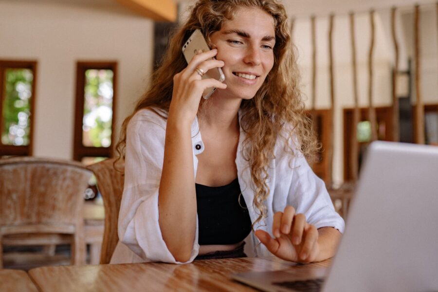 Photo of Woman Using Cellphone While Smiling