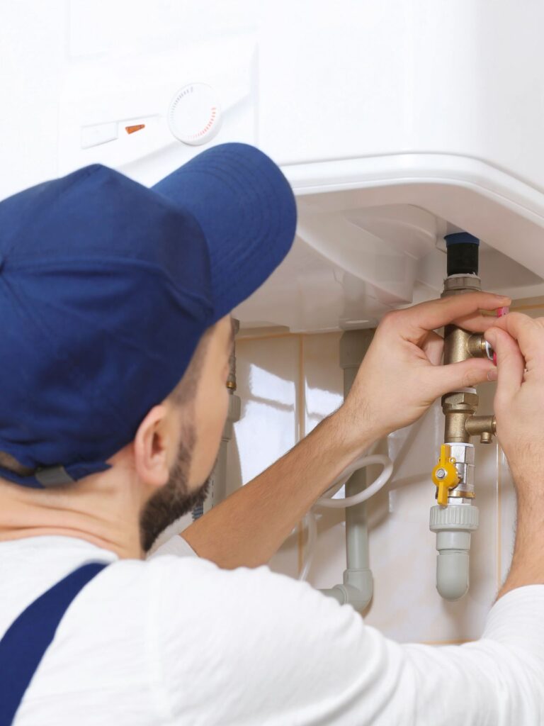 Plumber Installing Water Heater in Bathroom